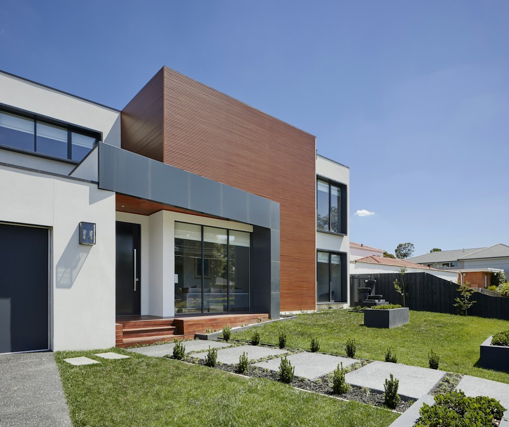 Inspector handing report to happy home buyers in front of house
